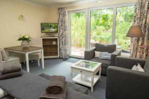 a living room with a couch and a table at Dieksee-Eck am See in Malente