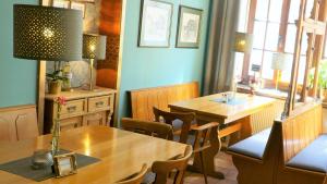 a dining room with two tables and a table and chairs at Hotel Dalberg in Sankt Martin