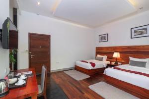 Postel nebo postele na pokoji v ubytování King Rock Boutique Hotel