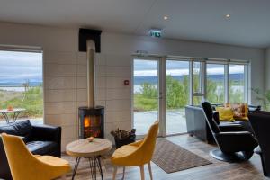 a living room with furniture and a fireplace at Hotel 1001 Nott in Egilsstadir