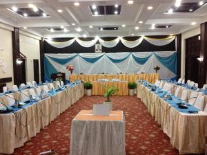 a banquet hall with rows of tables and chairs at Mombasa Continental Resort in Shanzu