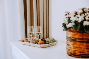 a tray of fruit and wine glasses on a table at Dimora Anderì in Polignano a Mare