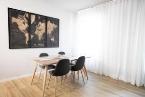 a table and chairs in a room with a map on the wall at Donizetti Residence in Bergamo