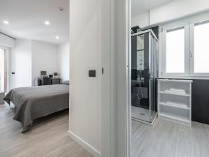 a white room with a bed and a mirror at Diaz Apartment in Cagliari
