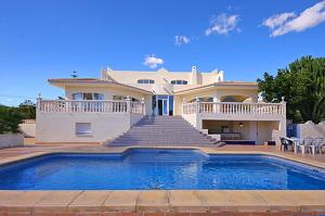 a large house with a swimming pool in front of it at Villa Cora in Jávea