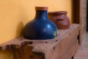 a blue vase sitting on top of a wooden table at Casa Rural Inma in Muñoveros