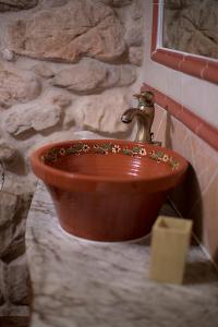 a wooden sink with a copper faucet in a bathroom at Casa Rural Inma in Muñoveros