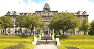 a large building with stairs in front of it at Palace Hotel & Spa Buxton in Buxton
