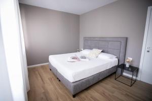 a bedroom with a white bed with a gray headboard at Donizetti Residence in Bergamo +47 photos