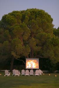 a group of chairs sitting in front of a screen at Mandraki Village Boutique Hotel in Koukounaries