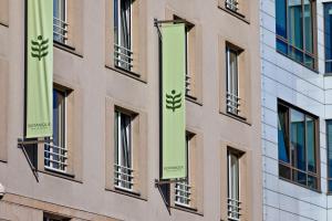a building with green banners on the side of it at Botanique Hotel Prague in Prague