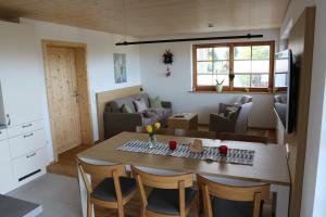 a kitchen and living room with a table and chairs at Schwarzwaldhuus Feldberg in Feldberg