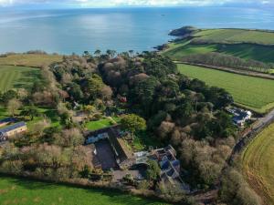 an aerial view of a house on a hill next to the ocean at Hotel Meudon in Falmouth