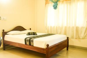 a bed sitting in a room with a window at Araliya Blue Beach View Hotel in Negombo
