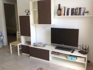 a living room with a flat screen tv on a counter at Sonder in Caleta De Fuste
