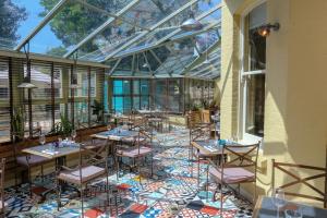a restaurant with tables and chairs in a glass ceiling at The Canford in Poole