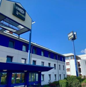 a building with a sign on the side of it at CREO Hotel Dessau in Dessau