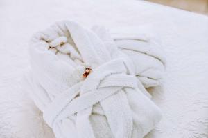 a bed with a white blanket with a bug on it at Dimora Anderì in Polignano a Mare