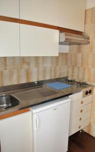 a kitchen with a sink and a counter top at Residence Carducci in Cesenatico