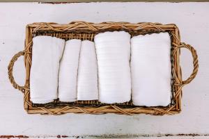a basket of toilet paper on a white wall at Dimora Anderì in Polignano a Mare