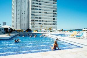 a group of people in a swimming pool at 6 personas FRENTE AL MAR- Complejo LINCOLN CENTER- Torre WASHINGTON in Punta del Este