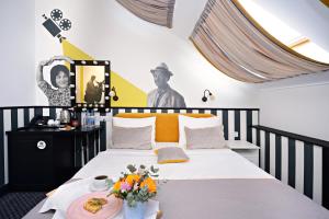 a bedroom with a bed with a plate of food on it at Design Hotel Sofit in Moscow