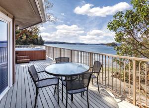 a table and chairs on a deck with a view of the water at WorldMark Deer Harbor in Deer Harbor