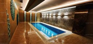 a swimming pool in a room with a brick wall at Taksim leylak suite in Istanbul