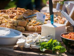 a table with different types of cheese and other foods at Gastronomy Hotel Kritsa in Portaria