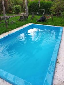 a large blue swimming pool in a yard at QUINTA EN OPEN DOOR-LUJÁN in Luján