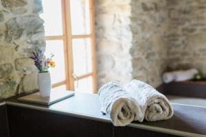 a bathroom with towels on a counter with a window at B&B Barbaia in Levice +67 photos