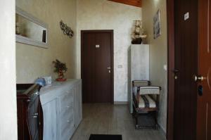 a kitchen with a counter and a refrigerator and a door at B&B Le Mansarde in Pescara