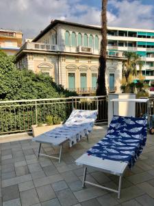two beds sitting on a patio with a building in the background at Casino' Porta -Teatro in Sanremo