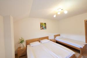 a room with two beds in a room at Grand Apartments-For Groups in Sarajevo