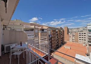a balcony with a table and a view of a city at Barcelonaforrent The Sagrada Penthouse in Barcelona