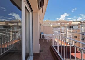 a balcony of a building with a table and chairs at Barcelonaforrent The Sagrada Penthouse in Barcelona