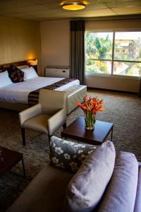 a hotel room with two beds and a couch at Mamba Point Hotel in Monrovia