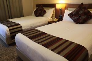 Katil atau katil-katil dalam bilik di Mamba Point Hotel