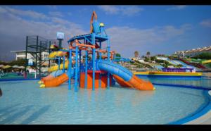 a water park with a water slide in the water at Torrox Pueblo Hidden Gem, 2 Bed Apartment in Torrox