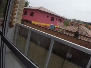 a balcony with a view of a building with a train on it at Praia Castelhanos - ES in Anchieta