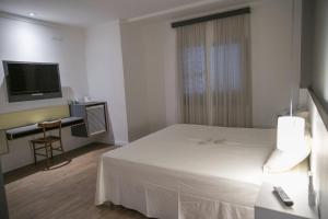 Llit o llits en una habitació de Uniclass Hotel Pinheiros