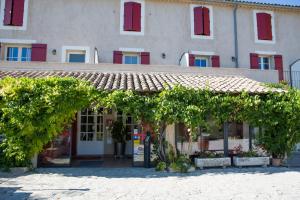 a building with a bunch of trees in front of it at Hotellerie du Domaine de Cabasse in Séguret