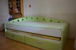 a bed in a room with greenitures at Royal Telavi in Telavi