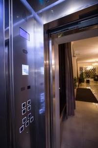 a elevator in a building with a blue light at Meliton Hotel in Krasnodar