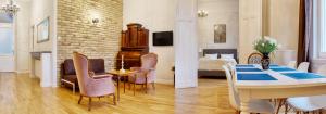 een woonkamer met een tafel en stoelen en een slaapkamer bij 4BR , 3BHR with AC at the OPERA in Boedapest