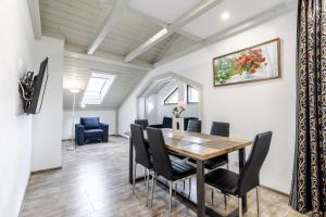 a dining room with a table and chairs at Villa Gor Apartments in Bukovel