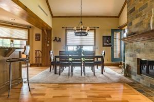 a dining room with a table and a fireplace at L'Équinoxe Rendez-Vous Mont-Tremblant in Mont-Tremblant