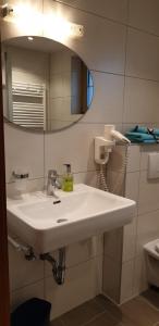 a bathroom with a white sink and a mirror at Spisshof in Grins +55 photos