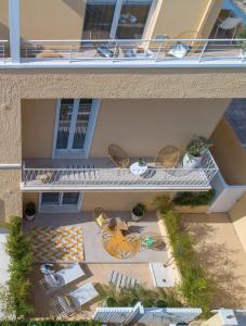 an overhead view of a balcony with chairs and tables at Le Palmette Suites in Cagliari