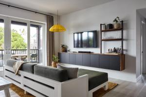 a living room with a couch and a tv at Lokal Hotel Cape May in Cape May